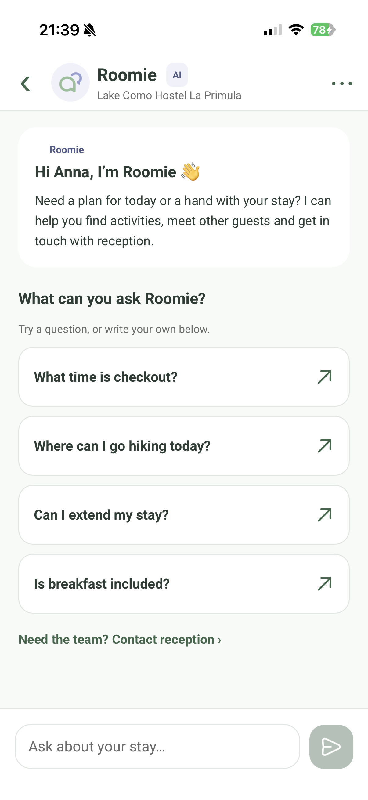 Current Roomie AI concierge screen with suggested questions and a link to contact reception